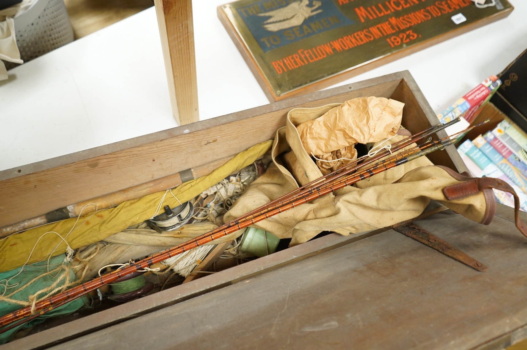 A collection of split cane fishing rods, reels, landing net etc contained in a large wooden box